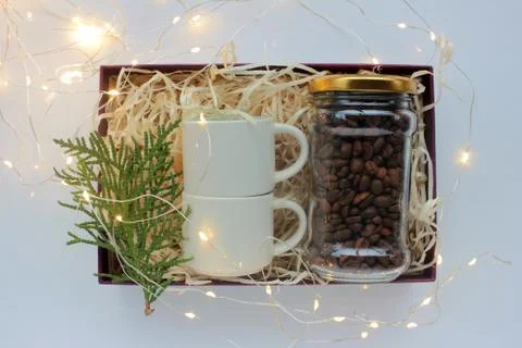 Christmas gift box with coffee beans and espresso coffee cups. Stock Photos
