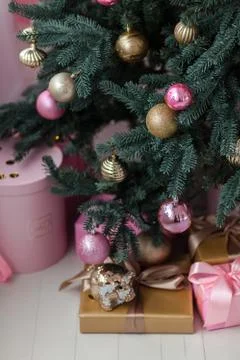 Christmas gift box with decorations near the New Year tree. Stock Photos