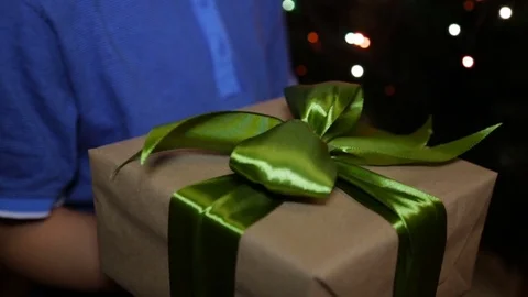 A Christmas gift box in the hands of a child Stockbeeldmateriaal 82137685