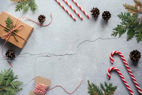Christmas gift box, pine cones, thuja branches and wrapping cord flat lay Stock Photos
