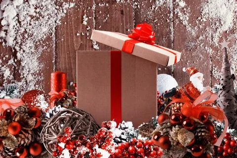 Christmas gift box presented in the middle of Christmas decorations on wood.. 写真素材