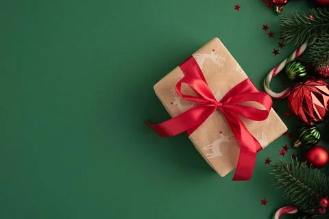 Christmas gift box with reindeer pattern and festive decorations Stock Photos