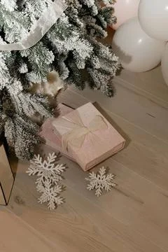 Christmas gift box under decorated tree with snowflake ornaments Stock Photos