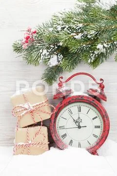 Christmas gift boxes, alarm clock and fir tree branch Stock Photos