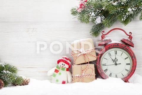 Christmas gift boxes, alarm clock and fir tree branch Stock Photos