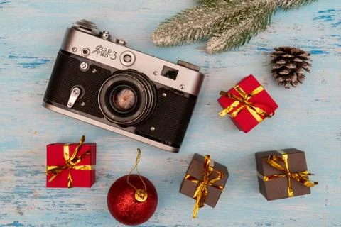 Christmas gift boxes and camera. Stock Photos