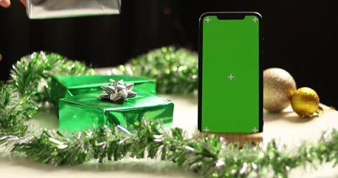 Christmas gift boxes and a green screen phone with festive decorations Stock Footage 339071524