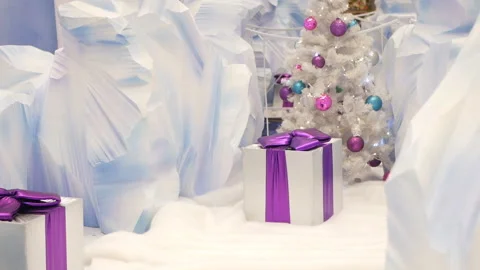 Christmas gift boxes and new year tree with glowing garlands, winter location wh Stock Footage 99257323