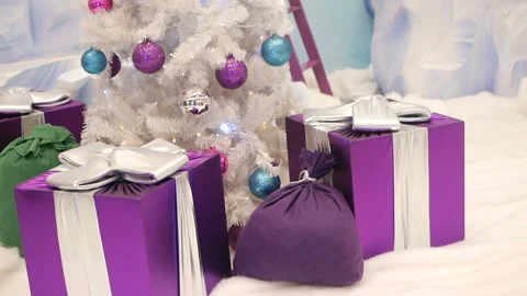 Christmas gift boxes and new year tree with glowing garlands, winter location wh Stock Footage 99260772