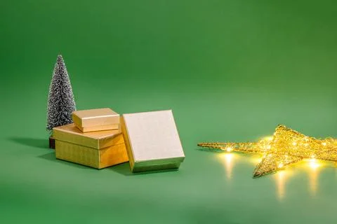 Christmas gift boxes and tree with lights. Christmass decoration on green b.. Stock Photos