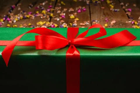 Christmas gift boxes with copy space. Green gift with red ribbon on wooden .. Stock Photos