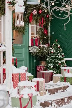 Christmas Gift Boxes with Decorated Pine Tree on Snowy Porch Stock Photos
