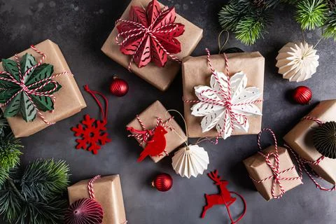 Christmas gift boxes decorated with red, green, white snowflakes made of pape Stock Photos