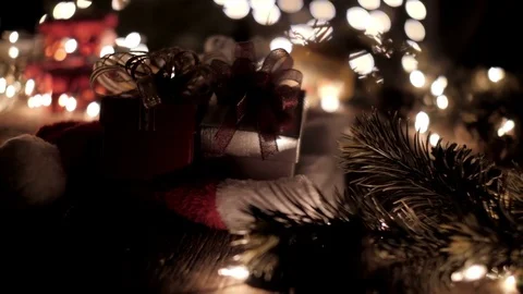 Christmas gift boxes decoration on Santa hat with tree and bokeh lights Stock Footage 80815212
