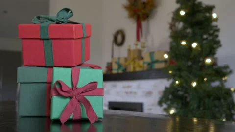 Christmas gift boxes on a table with other and tree on background Video stock 166288610