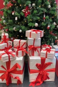 Christmas gift boxes under christmas tree close up, new year and christmas ho Stock Photos