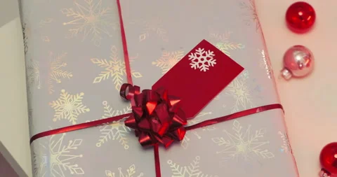 Christmas gift close-up. Label postcard, Red Christmas tree decorations. Stock Footage 145615560