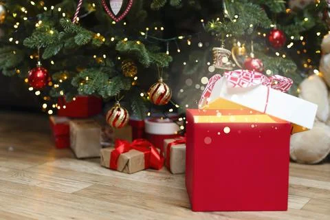 Christmas gift with magic light and blurred lights. Stock Photos