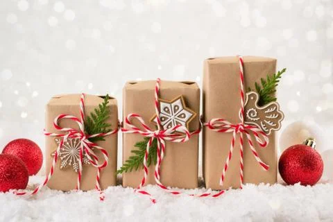 Christmas gift or present box wrapped in kraft paper with decoration on white Stock Photos