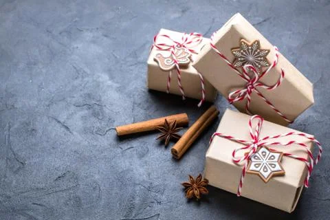 Christmas gift or present box wrapped in kraft paper with decoration on dark Stock Photos