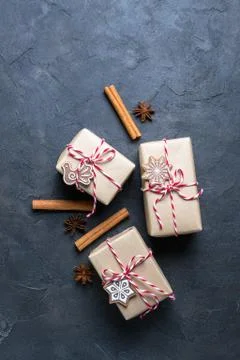 Christmas gift or present box wrapped in kraft paper with decoration on dark Stock Photos