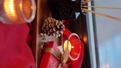 Christmas gift, pine cone and candles on window Stock Footage 144751729