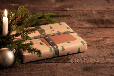 Christmas gift on rustic table at candlelight Stock Photos