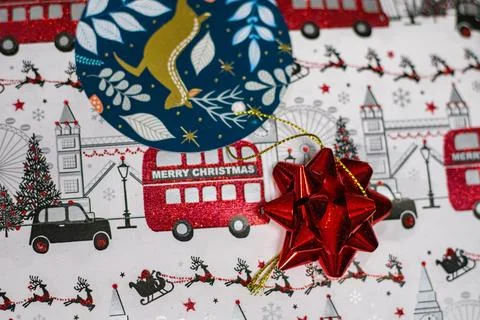 Christmas Gift Wrap with Red Bow, London-Themed Design, and Circular Tag Stock Photos