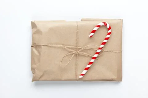 Christmas gift wrapped in brown craft paper, tied with scourge, decorated wit Stock Photos