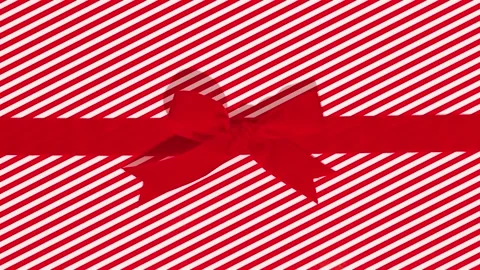 Christmas gift wrapping paper with a bow tearing on a green background. Stock Footage 320907826