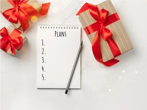 Christmas gifts boxes notepad with text Goals white background New Year concept Stock Photos