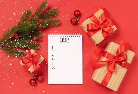 Christmas gifts boxes notepad with text Goals on red background New Year concept Stock Photos