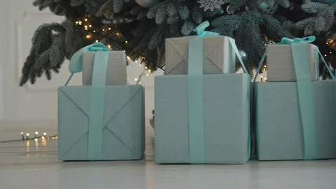 Christmas gifts in boxes under tree, close up Stock Footage 98089096