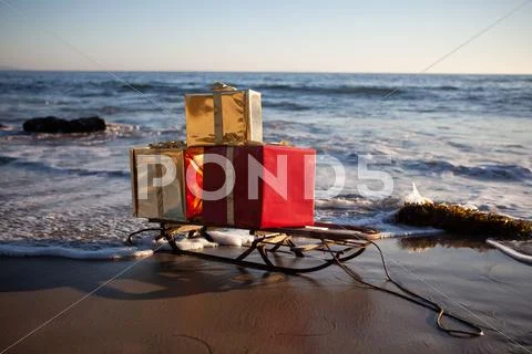 Christmas gifts on a sled on the beach in Malibu Stock Photos