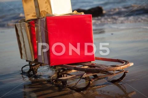 Christmas gifts on a sled on the beach in Malibu Stock Photos