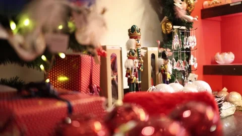 Christmas gifts under the tree with nutcracker figures glowing garland and brigh Stock Footage 318869445
