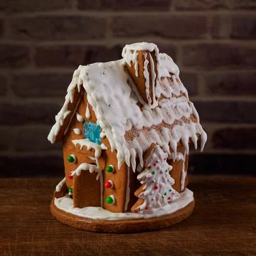 Christmas gingerbread house decorated with sugar icing and colorful candy Stock Photos