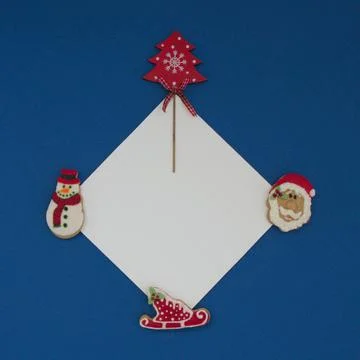 Christmas gingerbread with white copy paste on a blue background. Stock Photos