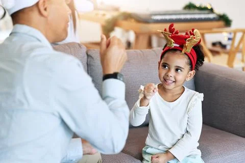 Christmas, girl and home holiday fun with a father and parent care on a living Stock Photos