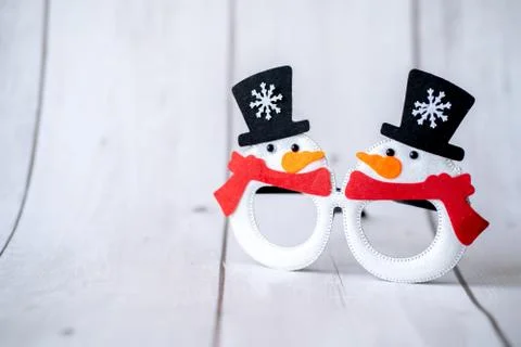 Christmas glasses with two snowmen in hats and with a red scarf with an orang Stock Photos