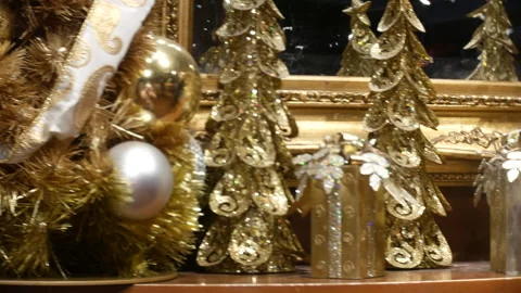 Christmas gold tree decorations and gift boxes on display shelf, festive Stock Footage 336597826