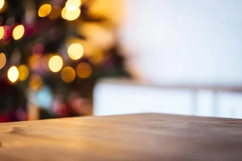 Christmas holiday background with empty rustic table and the bokeh of the liv Stock Photos