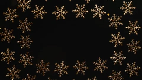 Christmas holiday background, gold snowflakes with glitter particles on black Stockbeeldmateriaal 157952257