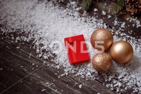 Christmas holidays background- red gift boxes on snow and decorations on wood Stock Photos