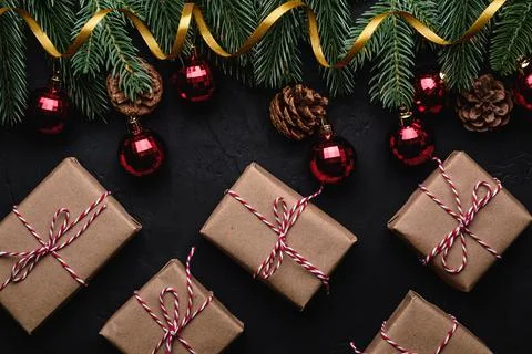 Christmas holidays composition. Gift boxes, golden ribbon, red ornament. Stock Photos