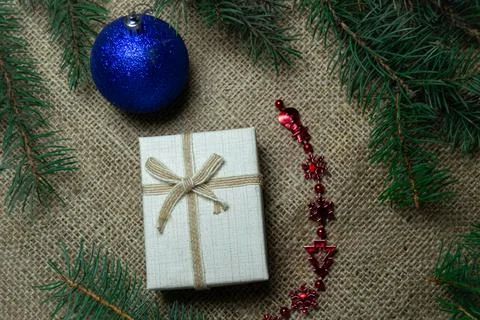 Christmas holidays composition with gift boxes, toys, coniferous tree branch. Stock Photos