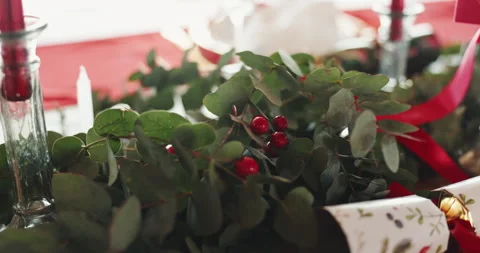 Christmas, holly decorations and table setting in dining room for festive Stockbeeldmateriaal 312868280