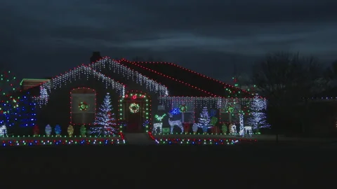 Christmas home, then pan to super-decorated home next door, 4K. Stock Footage 140081753