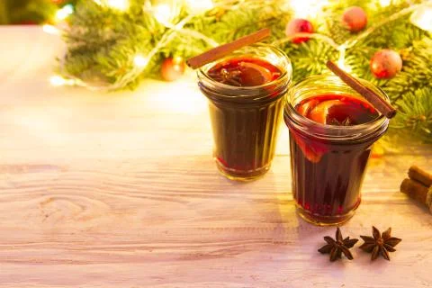 Christmas hot mulled wine with cinnamon cardamom and anise on wooden backgrou Stock Photos