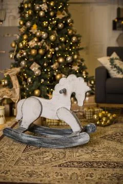Christmas interior with elegant Christmas tree and rocking horse Stock Photos